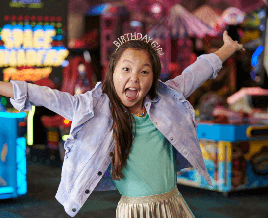 A little girl wearing a birthday crown