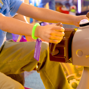 kid playing an arcade game